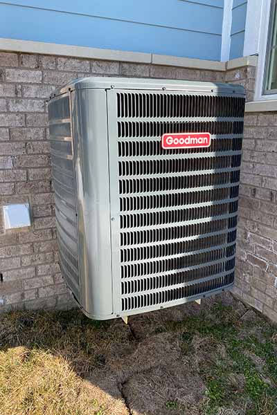 checking an outside HVAC system during a home inspection