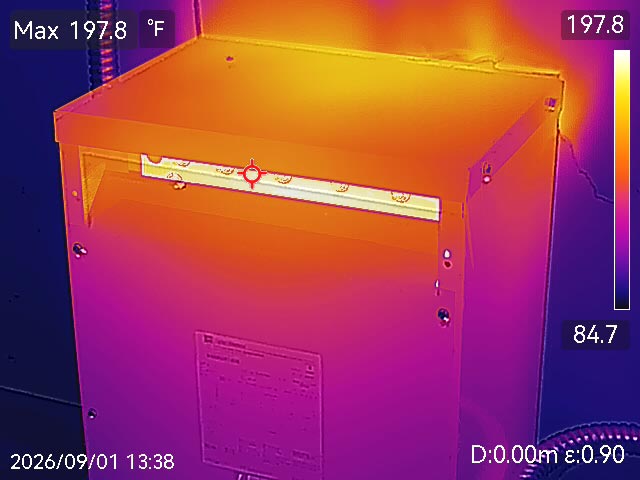 Thermal image showing multiple electrical components at varied temperatures, with scattered hotspots indicating ongoing system health monitoring
