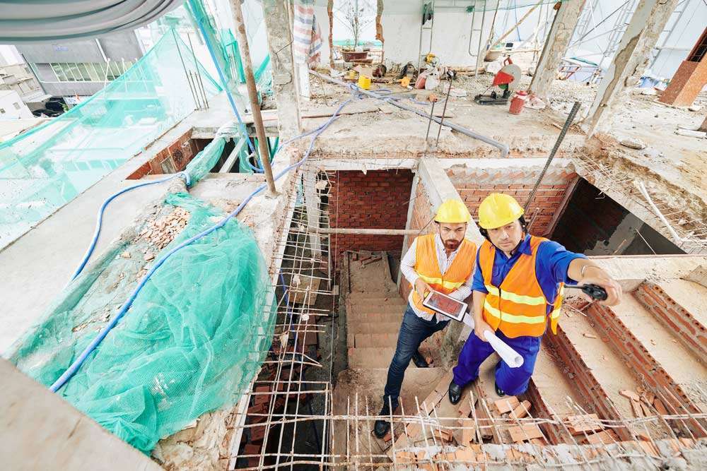 Commercial Draw Inspector helping construction worker