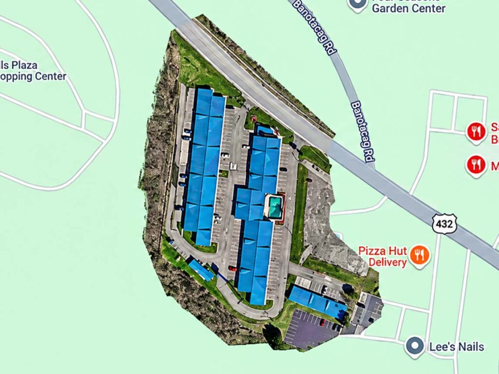 Aerial site map showing commercial buildings, parking lots, and paved access roads in St. Clairsville, Ohio.