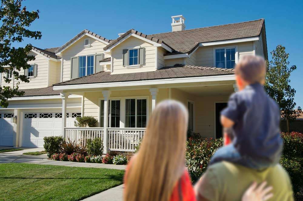 Couple and child looking at new home