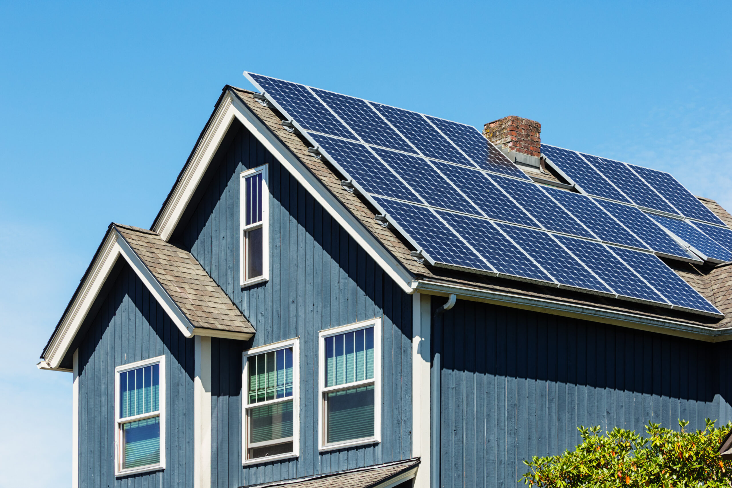 Photo of a small--town American home with energy-efficient solar panels on the roof.