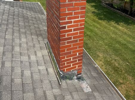 Improper roof flashing around a chimney identified during a professional home inspection.