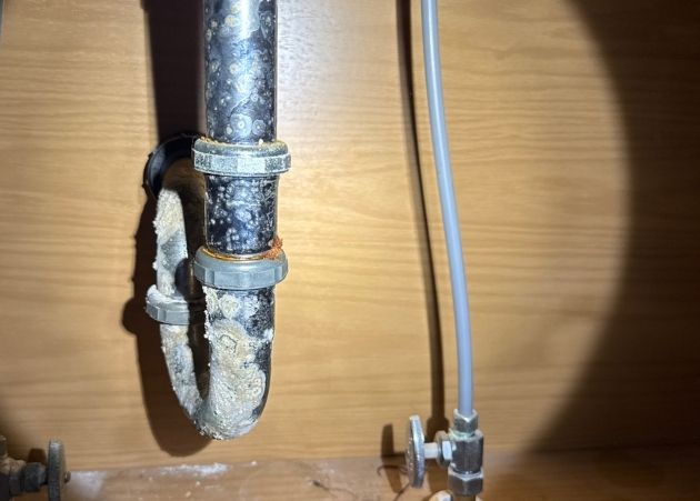 Corroded pipe fitting found during a plumbing inspection